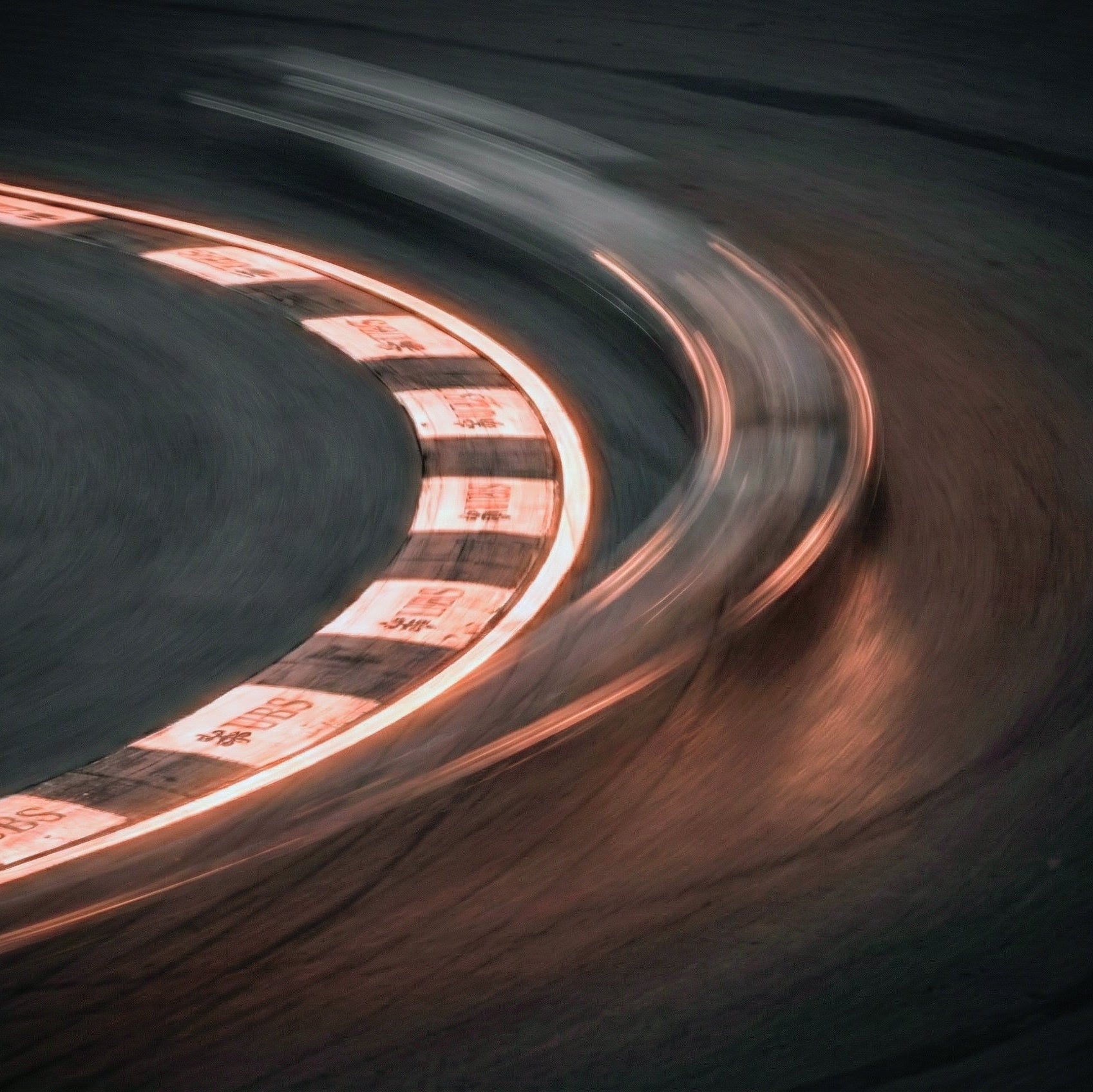 Formula 1 chicane image blurred car taking a neon curve